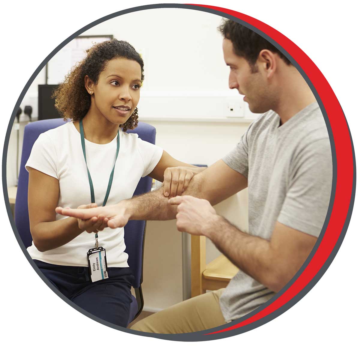 Female therapist evaluating a male patient’s arm during a physical therapy session in a clinic setting